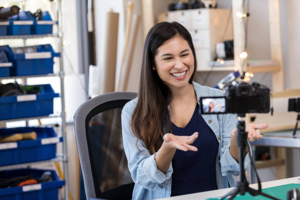 istock Mid adult female vlogger explains idea on video 1158889717