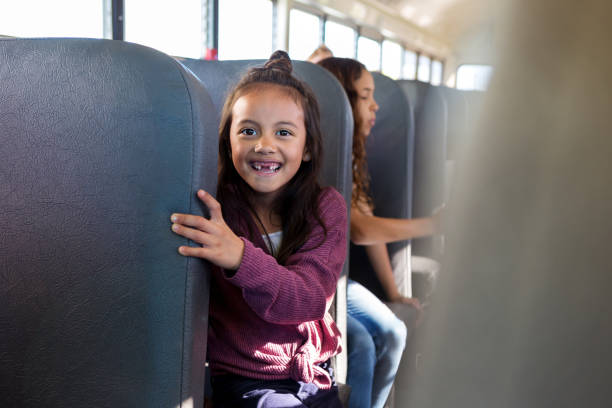 istock Smiling girl on school bus 1158889834
