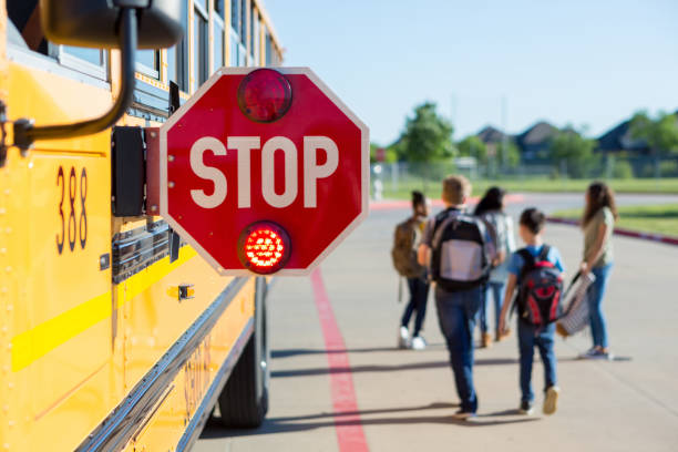 istock Because bus stop sign flashes, school children walk away safely 1158890062