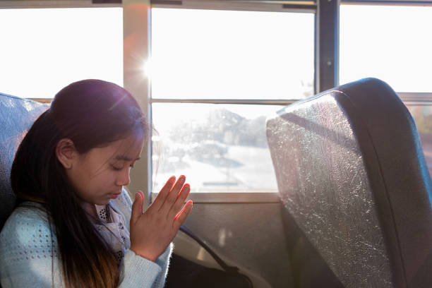 istock Young girl prays on bus 1158890085