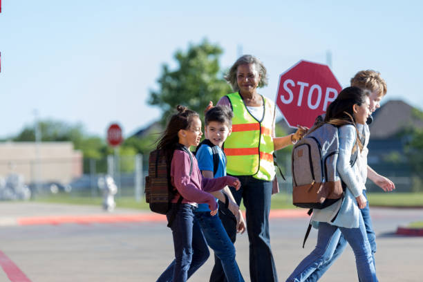 아이들은 정지 표지판을 들고 가드를 건너 산책 - crossing guard 뉴스 사진 이미지