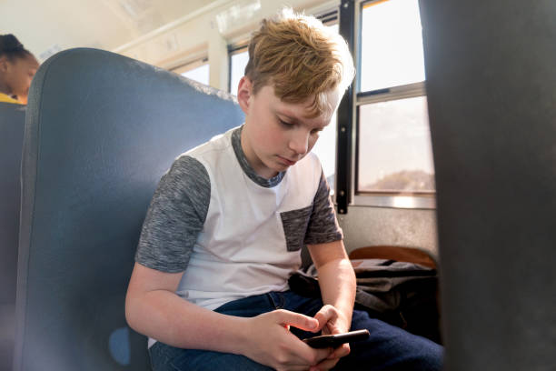 istock Preteen boy texts his mom while waiting on bus 1158890127