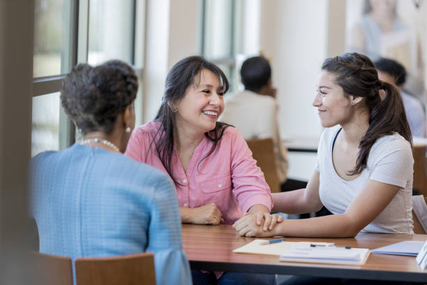 istock Mother and daughter exchange gazes while looking to the future. 1158890145
