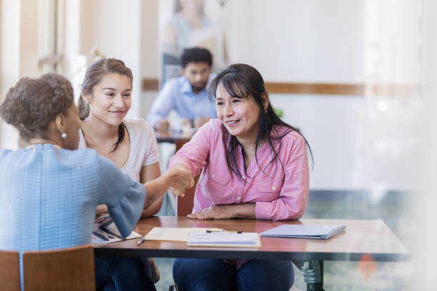 istock Mother shakes bank advisors hand while sealing the contract 1158890156