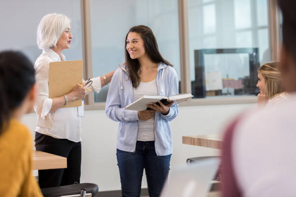 istock Teacher encourages female student after excellent presentation 1158890235