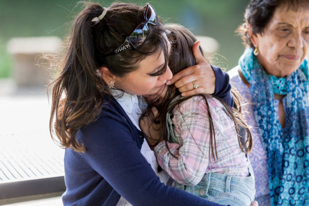 istock Distraught little girl seeks comfort from her mom 1158890291
