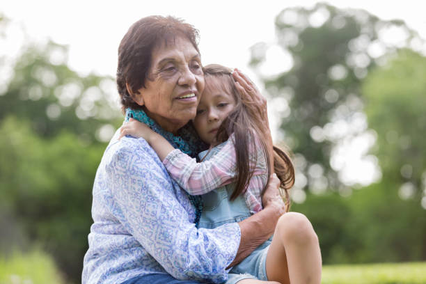 istock Senior woman comforts her young granddaughter 1158890307