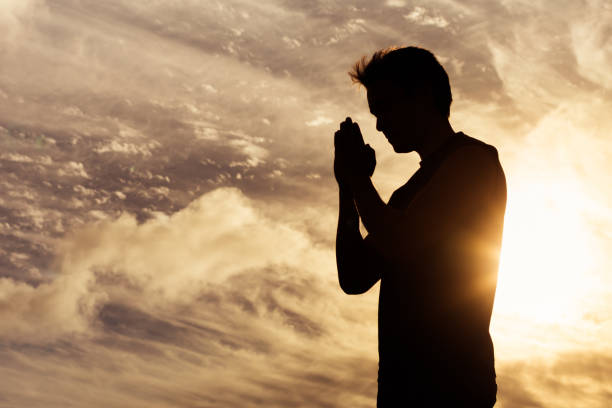 Silhouette of praying man at sunset Prayer and religion concept. saying grace stock pictures, royalty-free photos & images