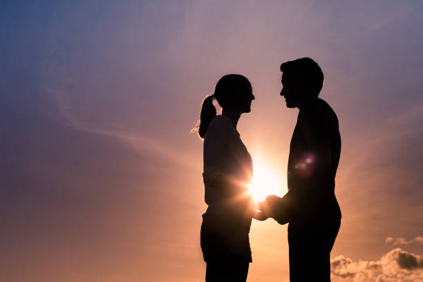 istock Young couple holding hands at sunset 1158890355