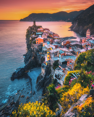 Colorful landscape view of  Vernazza village and harbor aerial view on beautiful sunset and flowers in Cinque Terre, Ligury, Italy. Seascape in Five lands in Cinque Terre National Park