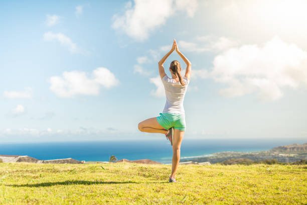 istock Woman doing yoga in a beautiful nature setting 1158891219