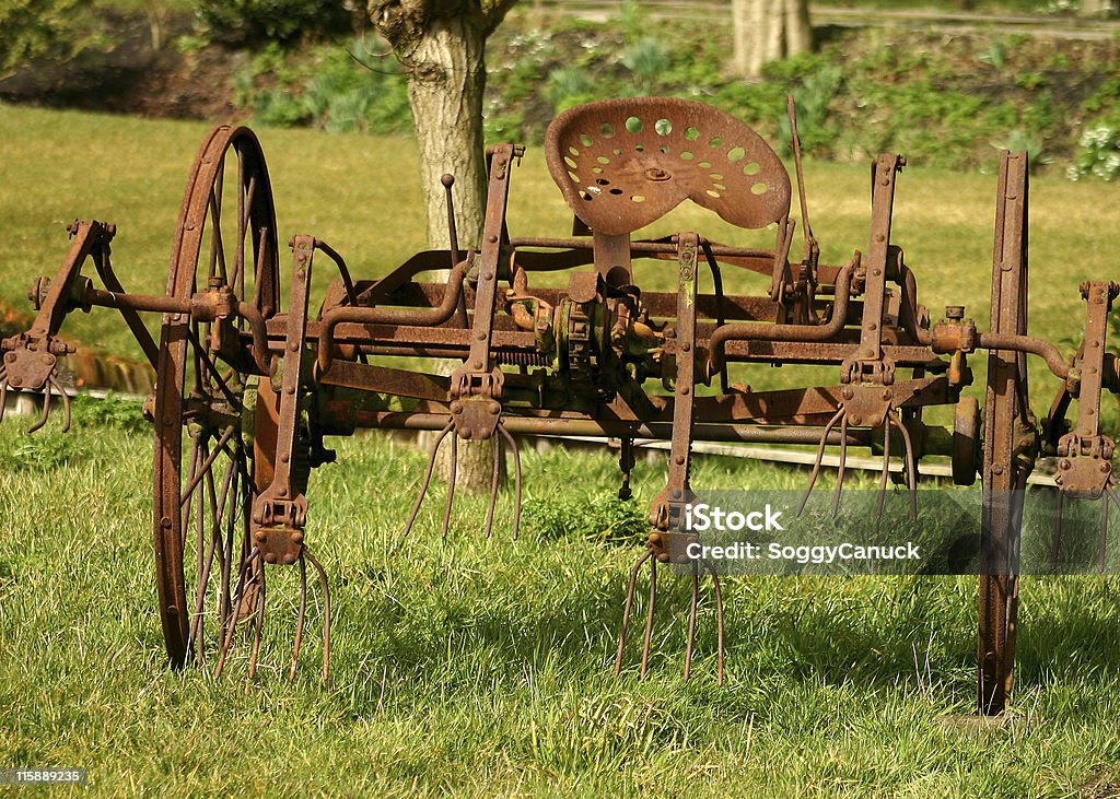 Rusted farm equipment A piece of rusted old horse-drawn farm equipment with seat Agriculture Stock Photo