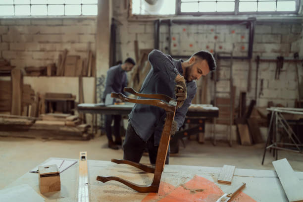 istock Carpenter Sanding a Wood With Hand Sander 1158893288
