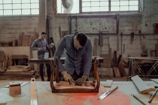 istock Carpenter Sanding a Wood With Hand Sander 1158893297