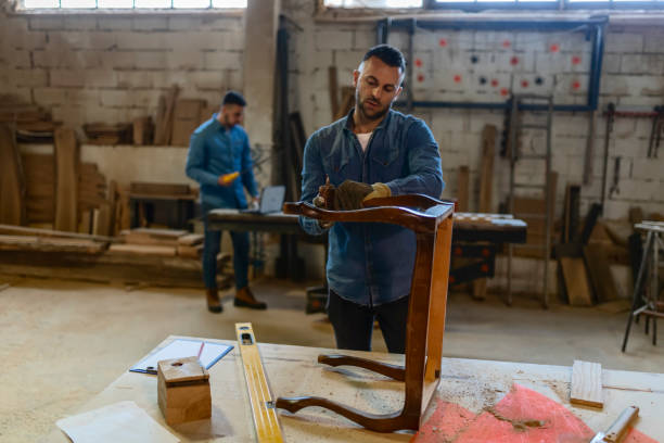 istock Carpenter Sanding a Wood With Hand Sander 1158893310