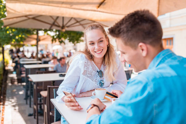 istock Young couple using a mobile phone in a bar 1158897645