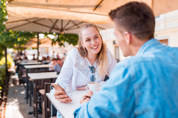 istock Young couple using a mobile phone in a bar 1158897655