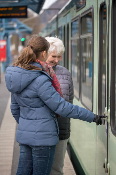 istock two women at tram stop 1158898653