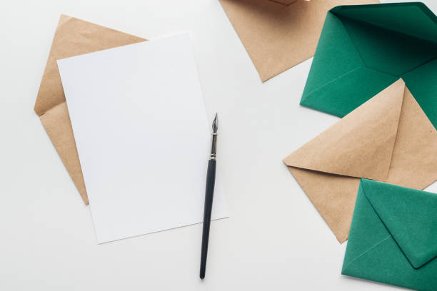 istock top view of empty card with ink pen, and envelopes on grey background 1158899354