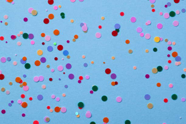 istock Round sequins on a  blue background with confetti. 1158900541