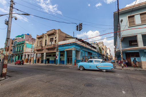 Havana, Cuba - May 14, 2019: Classic Old Taxi Car in the streets of the Old Havana City during a vibrant and bright sunny morning.