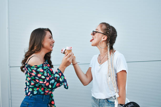 istock Beautiful women eating ice cream 1158901319