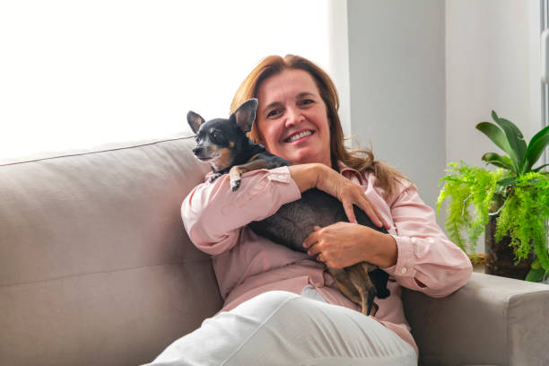 istock Business woman relaxing at home with her dog. 1158905983