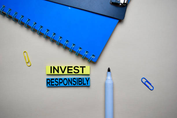 istock Invest Responsibly text on sticky notes with office desk. Stock Market Exchange Concept 1158906600