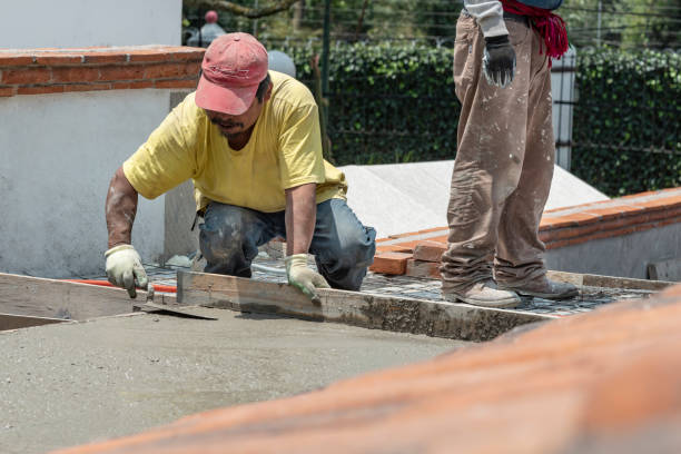 Bricklayer leveling a cement roof stock photo