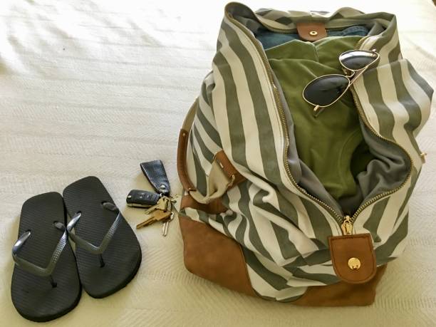 istock A duffle bag, flips flops and sunglasses in preparation for a road trip 1158908683