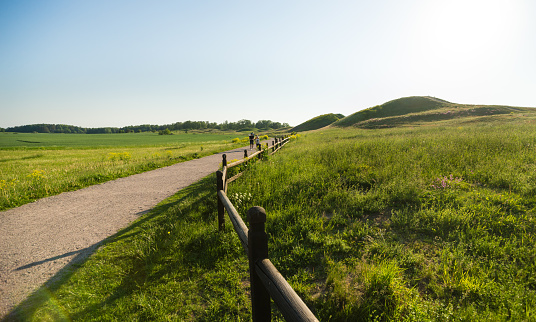 Uppsala, Sweden - June 6, 2019: Royal burial mounds in Gamla Uppsala. Gamla Uppsal was important religious, economic and political centre in first millennium AD.