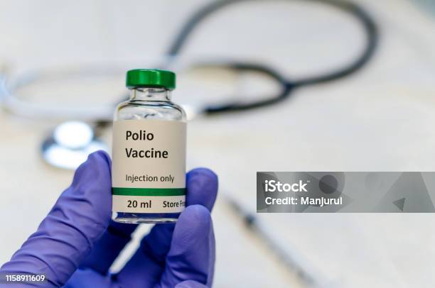 Polio Vaccine Vial Holding In Doctors Hand Stock Photo - Download Image Now - Polio Vaccine, Polio, Vaccination