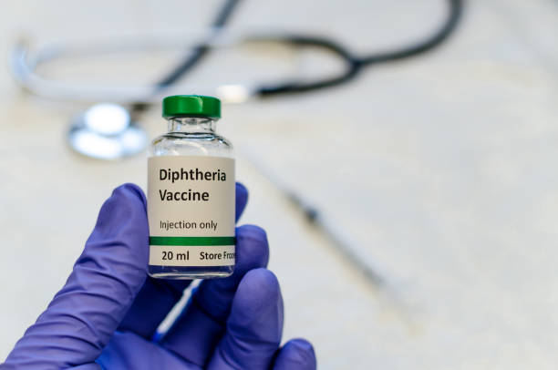 istock Diphtheria vaccine vial holding in hand 1158911638