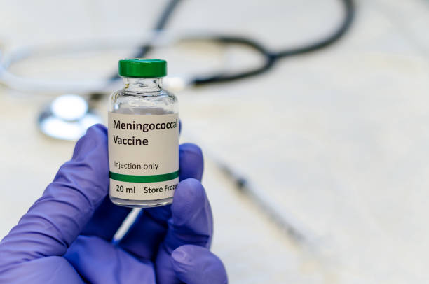 istock Meningococcal vaccine vial holding in hand 1158911639