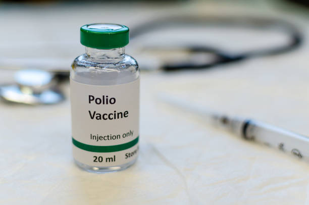 Poliomyelitis virus vaccine vial Polio vaccine vial with syringe and stethoscope at the background polio virus photos stock pictures, royalty-free photos & images