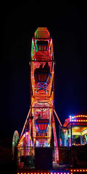 istock Ferris wheel at night with red light. 1158913423
