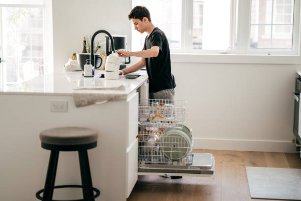 Teenager Helping Wash Dishes Teenager Helping Wash Dishes facet joint photos stock pictures, royalty-free photos & images