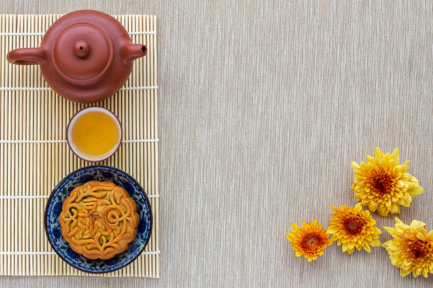 istock simple chinese mid autumn setting, mooncake, teapot and refreshing tea, chrysanthemum  flower and copyspace 1158916476