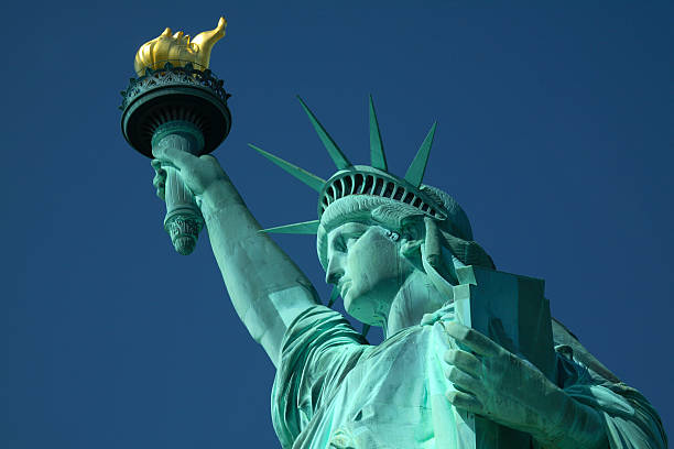 A closeup, upward pointing view of the Statue of Liberty stock photo