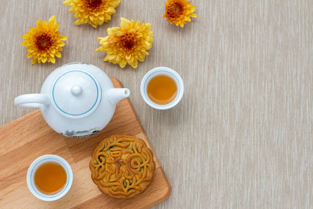 flat lay of chinese mid autumn mooncake and tea on table. copyspace available
