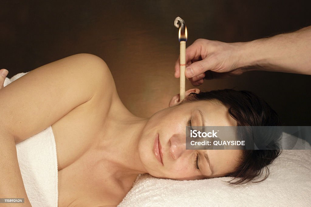 woman with ear candle therapy Ear Candling Stock Photo