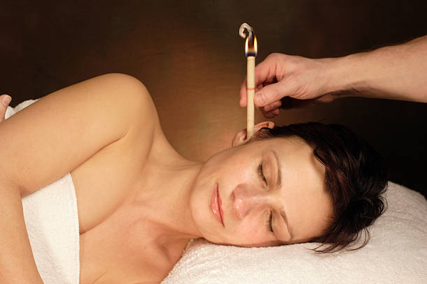woman with ear candle therapy woman with ear candle therapy hopi culture photos stock pictures, royalty-free photos & images