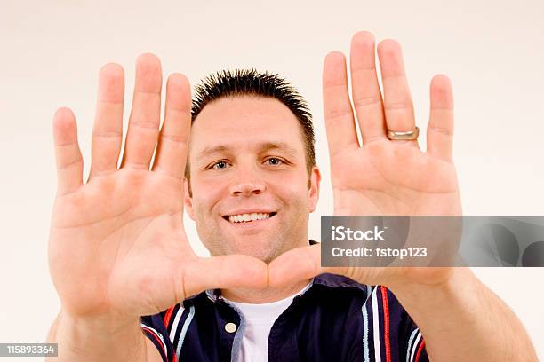 Young Man Holding Up 10 Fingers Palms Out Stock Photo - Download Image Now - Adult, Blue, Cheerful