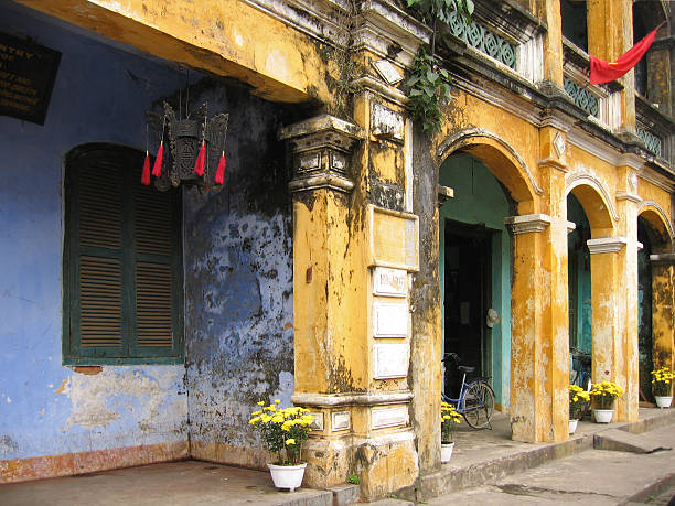 The golden yellow streets of Hoi An, Vietnam.  Decorated with flowers, flags and Chinese lanterns for Chinese New Year.