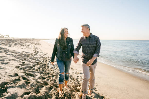 istock Seniors walking on the beach 1158940383