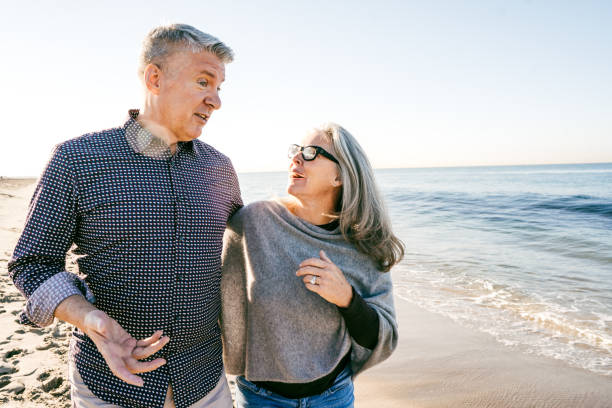 istock Seniors walking on the beach 1158940389
