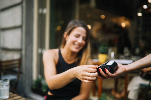 istock Young girl relaxing in a cafe, paying for drinks 1158944054
