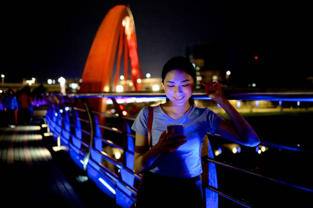 istock Young woman walking at raibow bridge 1158944093