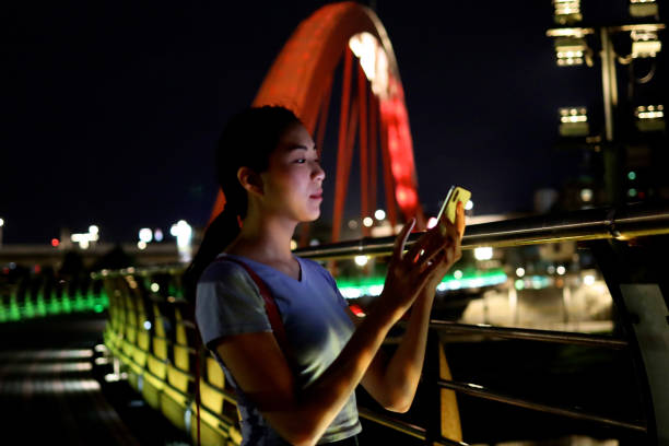istock Young woman walking at raibow bridge 1158944179
