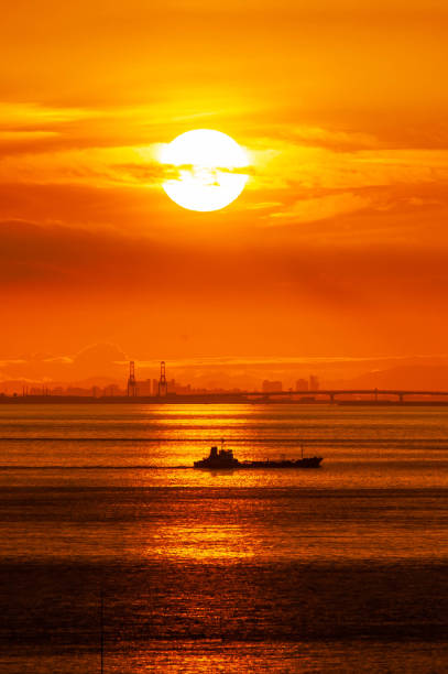 silhouette ship restaurant floating on water sea at sunrise
